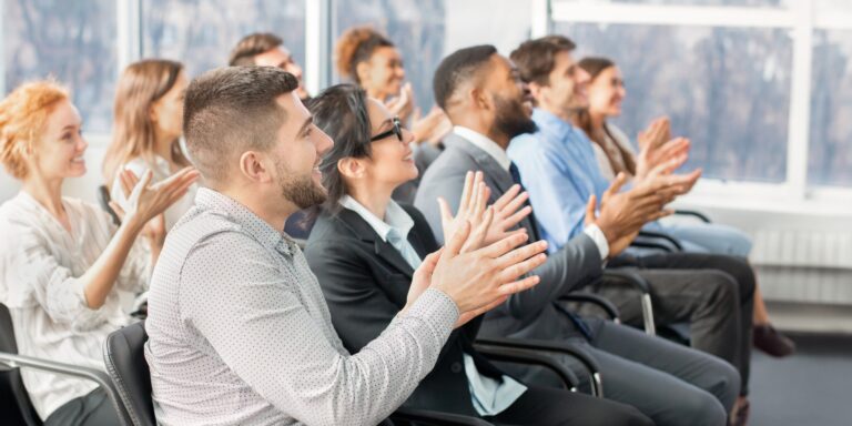 Grateful listeners. Business audience applauding to speaker